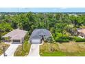 Expansive aerial view of a single Gathering home with pool and lush surroundings at 143 Crevalle Rd, Rotonda West, FL 33947