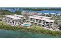 Beautiful aerial view of waterfront condos with a community pool and easy access to the bay at 1501 Beach Rd # 303, Englewood, FL 34223