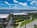 Aerial shot showcasing waterfront condos with white roofs, palm trees, lush landscaping, and stunning ocean views at 1551 Beach Rd # 212, Englewood, FL 34223