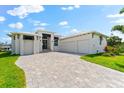 Charming home boasts a three-car garage, tiled driveway, and meticulously maintained landscaping at 15850 Viscount Cir, Port Charlotte, FL 33981