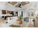 Stylish living area with contemporary furnishings, light wood flooring, and a clear view of the kitchen at 15850 Viscount Cir, Port Charlotte, FL 33981