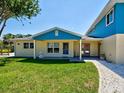 Charming home exterior featuring a lush green lawn and cozy front porch at 1605 Manor Rd, Englewood, FL 34223