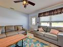 Inviting living room featuring stylish sofas and a decorative area rug at 1605 Manor Rd, Englewood, FL 34223