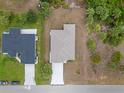 Birds eye view showcases the house's roof, driveway, and proximity to the neighboring property at 1664 Karluk St, North Port, FL 34287