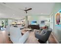 Spacious living room with modern furnishings, a large TV, and an open layout, perfect for entertaining at 171 Mark Twain Ln, Rotonda West, FL 33947