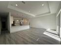 Open-concept living space with recessed lighting and wood-look flooring at 18043 Hillsborough Blvd, Port Charlotte, FL 33954