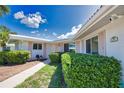 Landscaped front of house showing tidy bushes, walkway and address plaque at 19 Oakwood Dr N # 19, Englewood, FL 34223