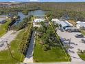 Aerial view of property showcasing a large lot, mature trees, and proximity to waterfront at 2060 Oyster Creek Dr, Englewood, FL 34224