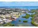 Stunning aerial view of waterfront community with lush landscaping and boat access to the beautiful open bay waters at 2117 Michigan Ave, Englewood, FL 34224