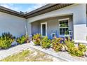 Inviting front porch with colorful landscaping, seating, and a well-maintained walkway leading to the entrance at 2678 Alva St, North Port, FL 34291