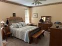 This bedroom features a decorative floral-themed border, ceiling fan, and coordinated bedspread and pillow set at 2864 Traverse Ave, North Port, FL 34286