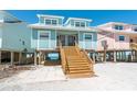 Stunning beach house exterior with stairs leading to a welcoming entrance and ocean views at 301 S Gulf Blvd # 3, Placida, FL 33946