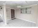 Enclosed and breezy outdoor patio featuring tile flooring and ceiling fan for relaxed, comfortable outdoor living at 407 Park S Blvd, Venice, FL 34285