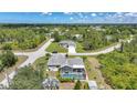 Aerial view of a home with a screened pool and lanai surrounded by lush landscaping at 4510 Burns Ter, Port Charlotte, FL 33981