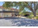 Exterior view of condo with carports and lush landscaping at 507 Pine Hollow Cir # 507, Englewood, FL 34223
