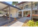 Well-maintained condo exterior featuring carport, walkway, and landscaping at 507 Pine Hollow Cir # 507, Englewood, FL 34223