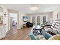 Inviting living room with wood floors, comfortable seating, and access to outdoor space at 507 Pine Hollow Cir # 507, Englewood, FL 34223