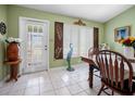 Bright dining room with white tile floors, a table, and a decorative window with ornate decor at 6417 Klaus Ct, Port Charlotte, FL 33981