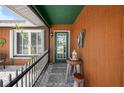 Covered entryway with a wooden table and chair creating a cozy and inviting entrance at 6417 Klaus Ct, Port Charlotte, FL 33981