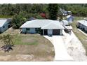 Aerial view of a quaint single Gathering home, including a front yard, driveway, and boat at 7234 Mamouth St, Englewood, FL 34224