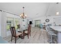 Dining room with natural light, chandelier, and easy access to kitchen and living area at 867 Cascade Ct, Englewood, FL 34223