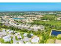 Expansive aerial shot showcasing a neighborhood near coastal waterways and lush greenery at 878 Fawnspring Ct, Englewood, FL 34223