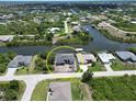 Beautiful aerial shot of home with canal access, boat dock, and surrounding residences at 10048 Winnipeg St, Port Charlotte, FL 33981