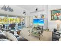 Cozy living room with comfortable leather seating, a glass coffee table, and a view of the pool at 116 Tournament Rd, Rotonda West, FL 33947