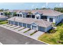 New condos featuring attached garages, manicured lawns, and modern neutral color scheme at 12470 Wellen Golf St # 108, Venice, FL 34293