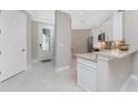 Modern kitchen featuring white cabinetry, stainless steel appliances, quartz countertops, and stylish backsplash tiles at 13859 Vadini St, Venice, FL 34293