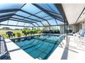 Inviting screened-in pool with golf course views, perfect for relaxation and recreation at 146 Rotonda Cir, Rotonda West, FL 33947