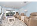 Comfortable living room with recliners, ceiling fan, and a view of the screened porch at 180 N Gulf Blvd # 5, Placida, FL 33946