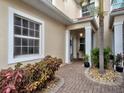 Inviting entrance with brick walkway, decorative plants, and cozy covered porch at 2590 Tarpon Cove Dr # 811, Punta Gorda, FL 33950