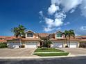 Charming townhomes featuring red tile roofs, lush landscaping, and inviting driveways at 2590 Tarpon Cove Dr # 811, Punta Gorda, FL 33950