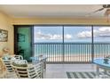 Bright sunroom with wicker furniture and a beautiful ocean view at 2700 N Beach Rd # B205, Englewood, FL 34223