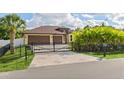 Gated entry and well-maintained landscaping enhancing curb appeal of this home at 2758 Morrietta Ln, North Port, FL 34286