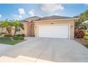 Inviting home featuring an attached two-car garage, ample driveway, and manicured landscaping at 278 Crystal River Dr, Englewood, FL 34223
