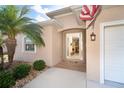 Home featuring a glass-paneled front door and tropical landscaping at 278 Crystal River Dr, Englewood, FL 34223