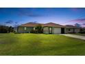 Charming single-story home with a well-maintained lawn and attached garage at 279 Mark Twain Ln, Rotonda West, FL 33947