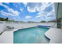 Sparkling pool with a white fence offers a refreshing oasis at 279 Mark Twain Ln, Rotonda West, FL 33947