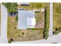 Aerial view of a single-story home with landscaping and neutral color roof at 305 E Wentworth Cir, Englewood, FL 34223