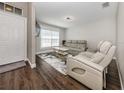 Bright living room features a modern sofa, stylish rug, and hardwood floors at 3695 Waffle Ter, North Port, FL 34286