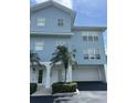 Charming blue townhome exterior featuring a private garage and well-manicured landscaping at 3929 Cape Haze Dr # 101, Rotonda West, FL 33947