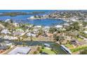 Aerial view of the canal front property with dock, waterfront homes, and lush greenery at 500 Green Dolphin S Dr, Placida, FL 33946