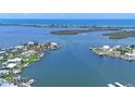 Aerial view showcasing a waterfront home in a scenic coastal community with docks at 565 Green Dolphin S Dr, Placida, FL 33946