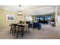 Charming dining and living area with neutral carpet, comfortable seating, and ocean view at 5700 Gulf Shores Dr # B-137, Boca Grande, FL 33921