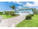Attractive one-story home with a brick-paved driveway and two-car garage at 8952 Scallop Way, Placida, FL 33946