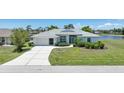 Charming single-story home featuring a well-maintained lawn and a driveway leading to an attached garage at 9064 Bantry Bay Blvd, Englewood, FL 34224