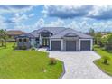 Beautiful single-Gathering home showcasing a 3-car garage, well-manicured lawn, and decorative stone facade at 9532 Miami Cir, Port Charlotte, FL 33981