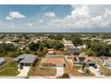 This aerial view showcases the home's location in a quiet neighborhood with mature trees at 10116 Melanie Ave, Englewood, FL 34224